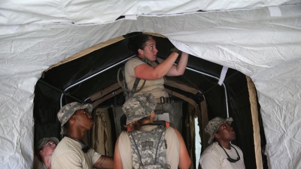 US Air Force personnel work to set up a 25-bed hospital to aid Liberian health workers infected with Ebola on Thursday.
