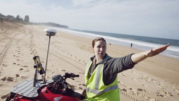 Melissa Mole carrying out research surveying the dunes on Narrabeen beach to study the effect of erosion by the sea.