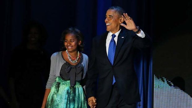 Winner ... US President Barack Obama walks on stage with daughter Sasha to deliver his victory speech.