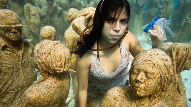TckTckTck partners Greenpeace and 350.org stage an underwater installation called  Silent Evolution  in Cancun.