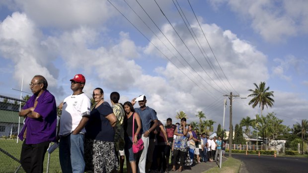 Native Fijians and ethnic Indians in a queue to vote in Fiji.