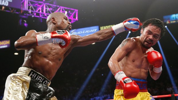 Money and power: Floyd Mayweather jnr during his unanimous points win over Manny Pacquaio in May's 'Fight of the Century'.