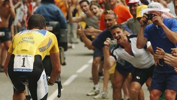 In the spotlight: Lance Armstrong runs the gauntlet during his 2004 Tour de France victory.