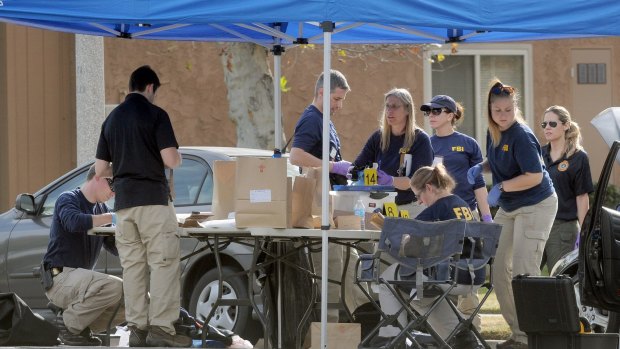 FBI officials continue pulling evidence from a car at the home of the San Bernardino mass shooting suspects.