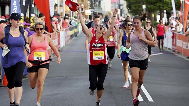 Runners cross the finish line in Manly.
