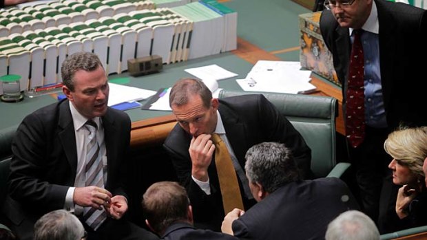 Tony Abbott in deep discussion with frontbenchers.