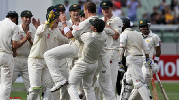 Fast bowler Peter Siddle is mobbed by teammates after taking the prize scalp of Pakistani captain  Mohammad Yousuf two balls before stumps.