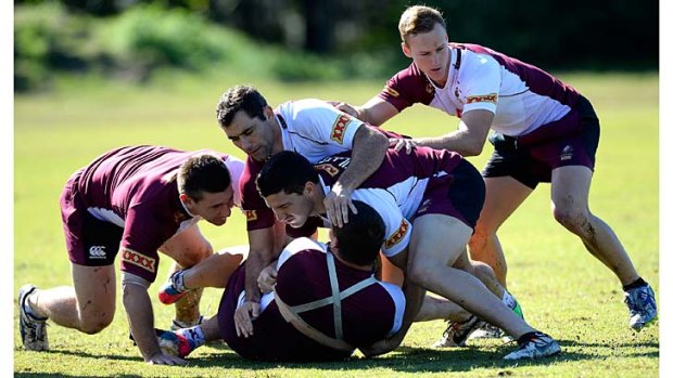 Matt Gillett and Cameron Smith defend during a Queensland Maroons state of origin training session on the Sunshine Coast on Monday.