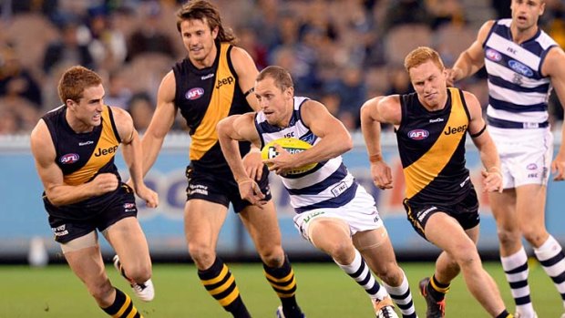Dash and carry: Geelong's James Kelly charges forward against Richmond at the MCG.