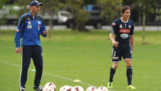 In charge: Kevin Muscat and skipper Mark Milligan at Melbourne Victory training on Friday. The team faces Adelaide in a crucial clash on Saturday night.