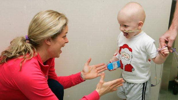 Kim Clijsters meets a young patient while on a visit to the Royal Brisbane Childrens Hospital on December 31.
