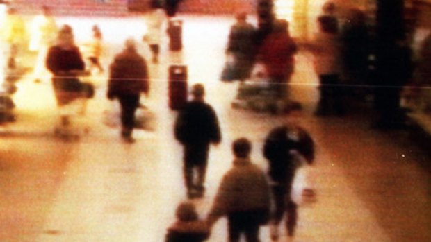 The grainy image from 1993 of two-year-old James Bulger being led away.