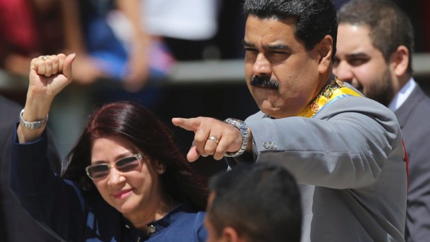 Venezuelan President Nicolas Maduro, right, and first lady Cilia Flores greet supporters in February.