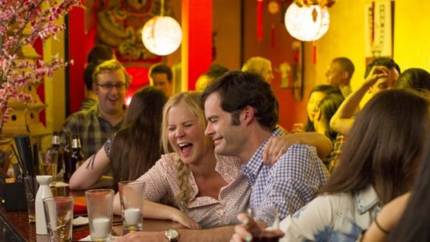 This photo provided by Universal Pictures shows, Amy Schumer , left, as Amy, and Bill Hader as Aaron, on a date in "Trainwreck," the new comedy from director/producer Judd Apatow. The movie releases in the U.S. on July 17, 2015.  (Mary Cybulski/Universal Pictures via AP)