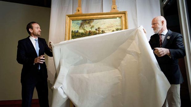 'Sunset at Montmajour': Director of the Van Gogh Museum in Amsterdam, Alex Ruge, left, and researcher Louis van Tilbourgh unveil a painting by Vincent van Gogh.