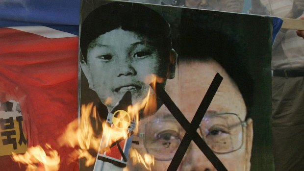 Pictures of North Korean leader Kim Jong-il and his son Kim Jong-un burnt during  anti-North Korea rally in Seoul last month.
