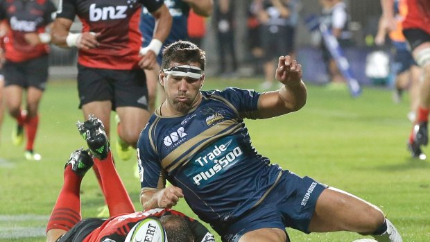 The Brumbies' Chris Alcock, right, and Crusaders' Wyatt Crockett compete for the ball.