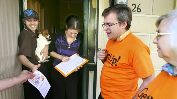GetUp! campaigner Selwyn Rodda signs up Kerry Chesher and Sarah Butler on a door knock in Kensington.