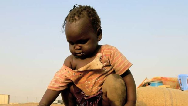 Heading home ... a South Sudanese child in Khartoum waits  for transport  to take her family to their  homeland, which gains full independence today.