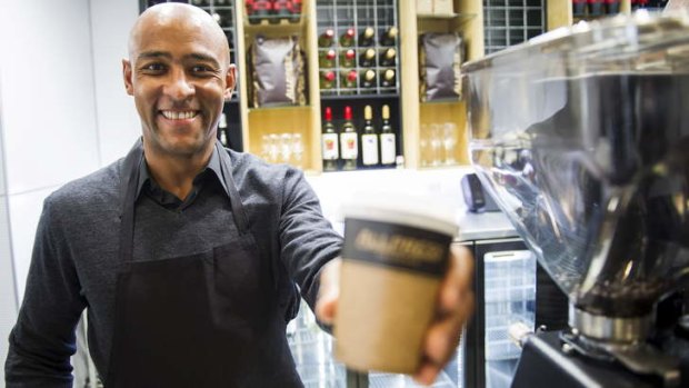 CAFFEINE HIT: George Gregan serves up a coffee at his new Canberra cafe at the Australian Institute of Sport on Thursday.