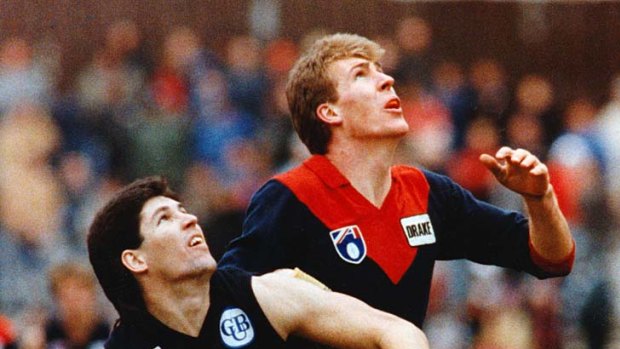 Stynes battles it out with Carlton's Steve Kernahan at Princes Park.