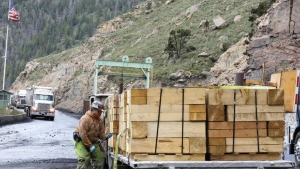 A worker unloads wood at the Sufco Coal Mine in Utah, which produces 30,000 tonnes of low-sulphur coal a day. US President Barack Obama's announcement is expected to target coal-fired power plants in a bid to reduce carbon emissions.