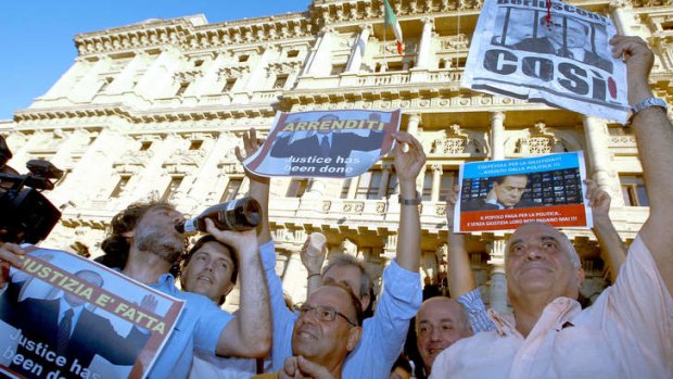 Demonstrators celebrate outside Italy's highest court building minutes after the sentence confirming a four-year term for Italian former Premier Silvio Berlusconi for tax fraud in Rome.