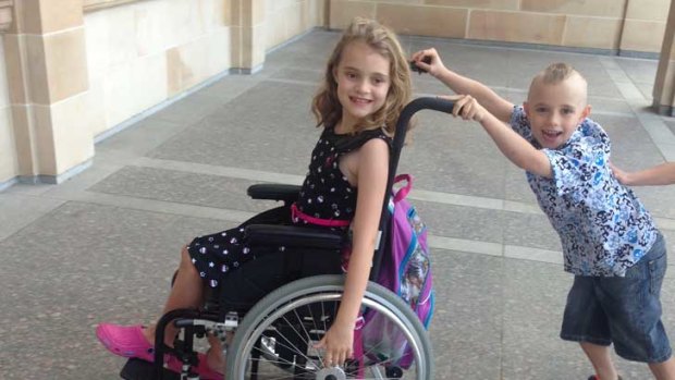 Lily Poulter enoys a push in her wheelchair from her younger brother Xander.