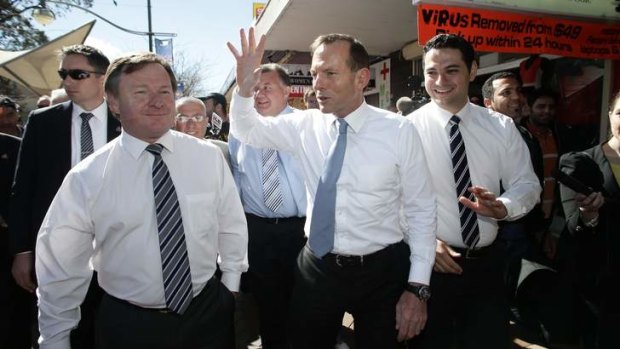 Opposition Leader Tony Abbott walks the streets of Liverpool, NSW with Kent Johns (left) , Liberal candidate for Werriwa.