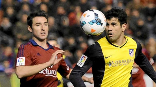 One that got away: Atletico de Madrid's Diego Costa of Brazil, right, vies for the ball with Osasuna's Marc Bertran.