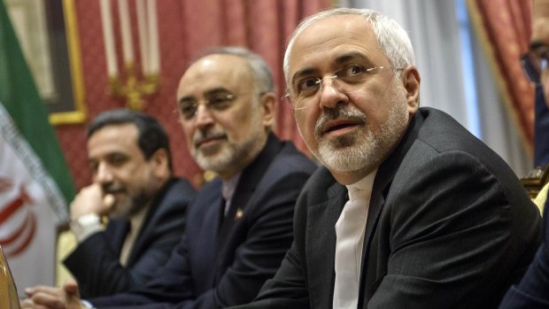 Looking to make a deal and lift sanctions ... Iranian Foreign Mohammad Minister Javad Zarif , right, waits for the start of a meeting with a US delegation at a hotel in Lausanne Switzerland  on Thursday.