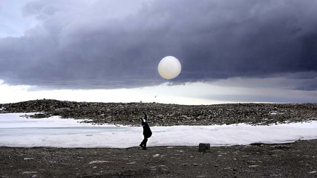 Up, up and away: Steven Black launches a weather balloon at Casey station in Antarctica.
