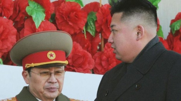 Missing: North Korean leader Kim Jong-un walks past his uncle, Jang Song-thaek, at a military parade in February last year. Photo: Reuters