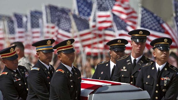 California return ... a military honour guard carries the coffin of one of America's latest Afghanistan fatalities, Sergeant Jason Weaver