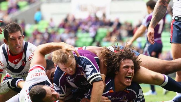Cook your chooks ... the Storm’s Kevin Proctor celebrates scoring a try against the Roosters.