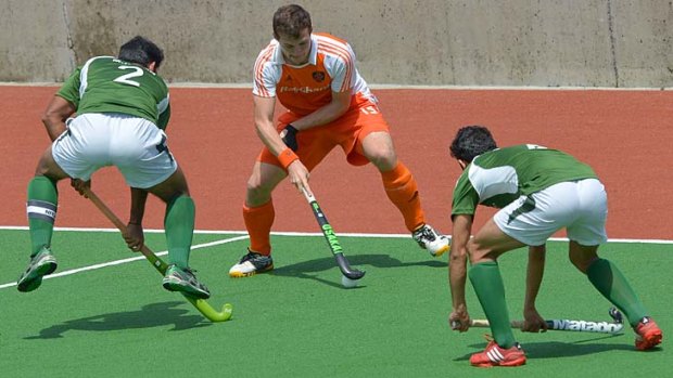 Caught on the hop: Dutch player Sander Baart fights through the Pakistani defence in the semi-final encounter.