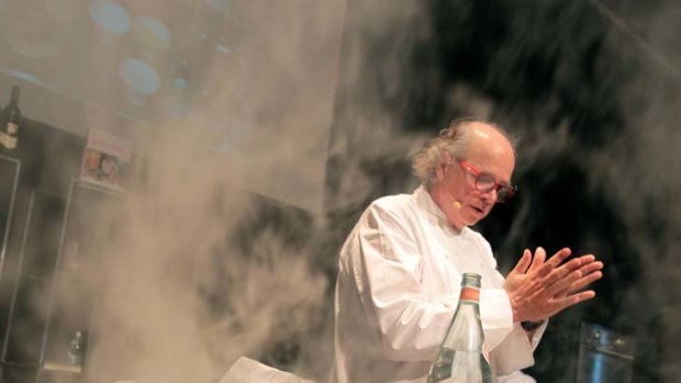 Smoke and the water ... Argentinian chef Francis Mallmann, one of the 13 international chefs who flew into town yesterday for the World Chef Showcase, demonstrates his skills at the Hilton Hotel.