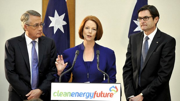 Julia Gillard delivers the carbon tax package in Canberra yesterday, flanked by Treasurer Wayne Swan (left) and Climate Change Minister Greg Combet.