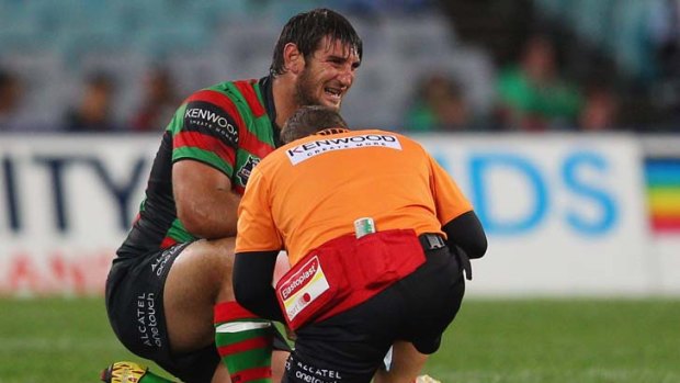 Feigning injury &#8230; Dave Taylor gets assistance from South Sydney's head trainer before rejoining the play.