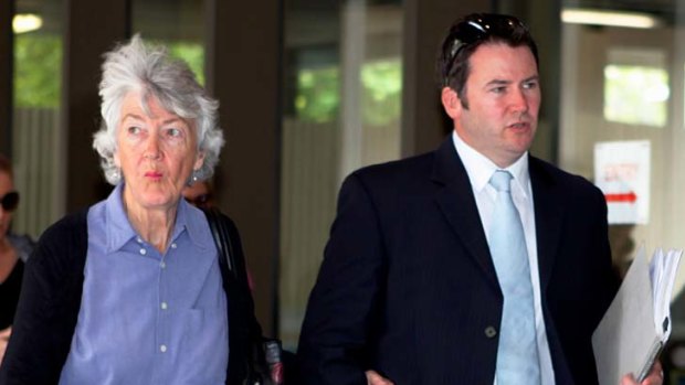 Insider trading ... Justin Hugh O'Brien arrives at court with his mother.