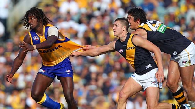 Big jumper: Eagle Nic Naitanui is challenged by Tigers Dustin Martin and Angus Graham.