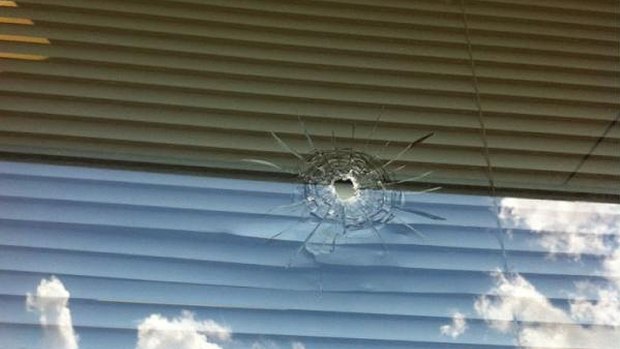 A photo of the bullet hole in the electorate office window of Michael Crandon, posted on Twitter by former LNP candidate Cameron Caldwell.