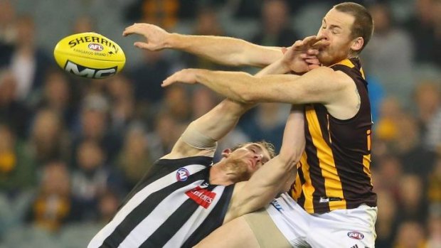 Hawthorn's Jarryd Roughead attempts to mark over  Lachlan Keeffe of Collingwood.