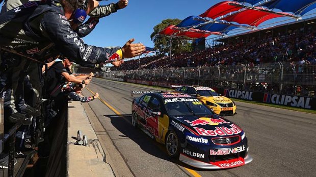 The Red Bull Racing crew celebrates as Craig Lowndes crosses the line to win race one of the Clipsal 500.