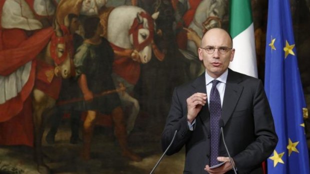 Italian Prime Minister Enrico Letta gestures during a news conference 