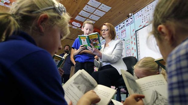 Prime Minister Julia Gillard reads with Jacob Stock at Latham Primary School in Canberra.