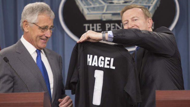 US Defense Secretary Chuck Hagel receives a New Zealand All Blacks rugby jersey from New Zealand Defense Minister Jonathan Coleman in Washington, DC.