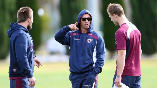 Halves in the shade: Andrew Johns talks to Kieran Foran, left, and Daly Cherry-Evans. 
