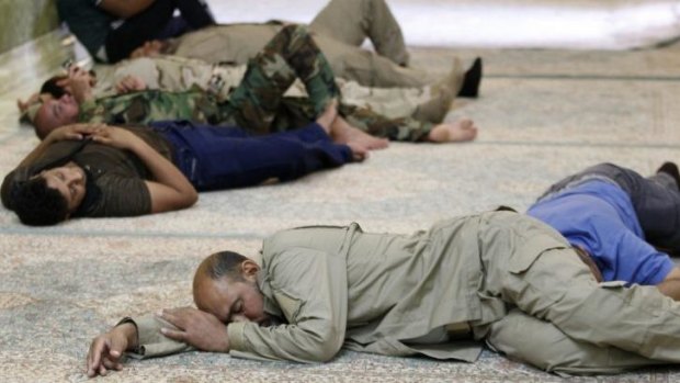 Shiite volunteers in support of the Iraqi Army get some rest inside the Imam al-Askari shrine in Samarra.