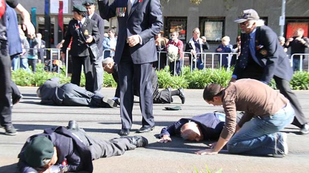 Injured war veterans lay on the road after they were hit by a trucki during last year's Anzac Day parade in Melbourne.